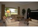 Inviting living room boasts comfortable seating, elegant decor, and a picturesque view of the lush outdoors at 13550 Thoroughbred Dr, Dade City, FL 33525