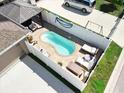 Aerial view of the backyard featuring a private pool with lounge chairs, patio, and white privacy fence at 13003 Upward Pl, Riverview, FL 33579