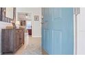 Inviting entryway with blue front door, wood floors, and a view into the living area of the house at 8461 Buttonquail Dr, Englewood, FL 34224