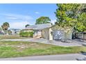 Charming single-story home with a well-maintained lawn, driveway, and a one-car garage on a sunny day at 3427 Minnow Creek Dr, Hernando Beach, FL 34607