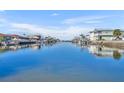 Beautiful canal view lined with waterfront homes and lush landscaping, creating a serene and picturesque scene at 3427 Minnow Creek Dr, Hernando Beach, FL 34607