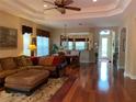 Open-concept living room with hardwood floors and neutral decor, seamlessly connecting to the dining area at 5271 Visionary Ct, Sarasota, FL 34233