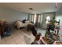 View of the cozy living room with neutral walls and bright tile flooring at 10128 Cherry Creek Ln, Port Richey, FL 34668