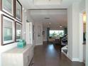 Inviting hallway featuring wood floors, stylish decor, and an open view into the spacious living area at 9558 Brave Buck Ave, Land O Lakes, FL 34638