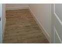 Hallway boasts neutral flooring, white baseboards and trim creating a seamless and modern aesthetic at 9572 Brave Buck Ave, Land O Lakes, FL 34638