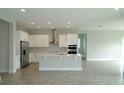 Bright, open kitchen featuring white cabinets, stainless steel appliances, and a central island at 9572 Brave Buck Ave, Land O Lakes, FL 34638