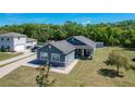 Aerial view of a well-maintained home and lawn, showcasing the spacious yard and neighboring houses at 3708 Alafia Creek St, Plant City, FL 33567