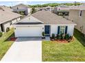 Inviting single-story home with a manicured lawn in a Gathering-friendly neighborhood with mature landscaping at 38370 Sonnet Landing Ave, Zephyrhills, FL 33540