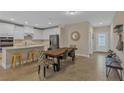 Bright kitchen featuring white cabinetry, stainless steel appliances, and tile flooring at 7575 Sea Oak Ct, Parrish, FL 34219