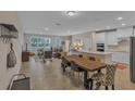 Open-concept living area with tile floors, seamlessly connecting to dining and kitchen at 7575 Sea Oak Ct, Parrish, FL 34219
