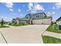 Attractive two-story home with a three-car garage, covered porch, and a long driveway at 11728 June Briar Loop, San Antonio, FL 33576