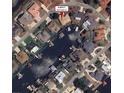 Aerial view of the neighborhood, surrounded by waterways, with the subject property marked in red at 802 Eagle Ln, Apollo Beach, FL 33572