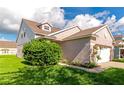 A charming home shows off its meticulously landscaped front yard with a full two-car garage at 4135 Rocky Fork Ter, Ellenton, FL 34222