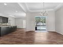 Bright living room featuring hardwood floors and sliding glass doors to the pool area at 11344 Gallinule Ave, Weeki Wachee, FL 34613