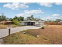 A charming home features a screened-in patio, carport and brick driveway at 4125 Worcester Rd, Sarasota, FL 34231