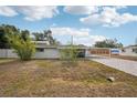 Side view of home featuring a screened-in patio and carport on a sunny day at 4125 Worcester Rd, Sarasota, FL 34231
