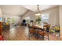 Open living room with a dining area, hardwood floors, and lots of natural light at 6175 Beechwood Dr, Dade City, FL 33523