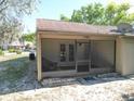 Enclosed screened patio with an exterior door, providing a comfortable outdoor living space at 6175 Beechwood Dr, Dade City, FL 33523