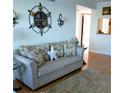 Cozy living room with a comfortable sofa, nautical decor, and plenty of natural light at 4310 Falmouth Dr # 301, Longboat Key, FL 34228