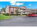 Inviting condo exterior with covered parking, manicured landscaping, and brick accents at 4804 Myrtle Oak Dr # 11, New Port Richey, FL 34653