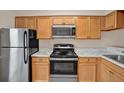 Efficient kitchen featuring stainless steel appliances, light wood cabinets, and countertops at 4804 Myrtle Oak Dr # 11, New Port Richey, FL 34653
