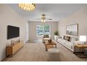 Inviting living room with plush carpet, modern furniture, and a bright window showcasing natural light at 4804 Myrtle Oak Dr # 11, New Port Richey, FL 34653