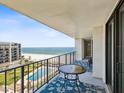 A furnished condo balcony overlooking the pool and Gulf of Mexico, offering breathtaking views of the beach at 1400 Gulf Blvd # 701, Clearwater Beach, FL 33767