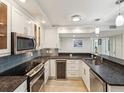 A bright kitchen features stainless steel appliances, granite countertops, and ample cabinet space at 1400 Gulf Blvd # 701, Clearwater Beach, FL 33767