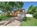 Beautiful two-story home featuring balconies and a brick-paved driveway at 16601 W Course Dr, Tampa, FL 33624