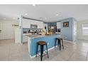 Bright kitchen with granite countertops, stainless appliances, and a central island with bar stool seating at 3270 Rock Sound St, Bradenton, FL 34208