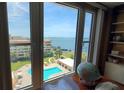 Bright view from the condo overlooking the community pool and bay with blue skies at 632 Edgewater Dr # 832, Dunedin, FL 34698