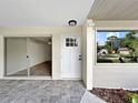 Inviting entryway featuring tiled flooring, a white front door, and a view into the spacious living area at 5136 Cedar Hammock Dr, Sarasota, FL 34232