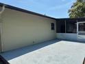 Covered and screened-in patio features painted flooring and a view of the surrounding yard at 7169 Holiday Dr, Spring Hill, FL 34606