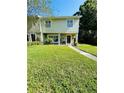 Charming townhome with a well-maintained lawn and landscaping leading to the front entrance at 15515 Morning Dr, Lutz, FL 33559