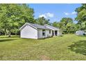Charming home featuring new landscaping, a stucco exterior, and a lush green lawn at 13091 Old Crystal River Rd, Brooksville, FL 34601
