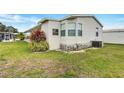 Back view of a home with vinyl siding, energy-efficient windows, and manicured landscaping at 9790 66Th N St # 89, Pinellas Park, FL 33782