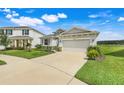 Attractive single-story house with a spacious driveway, neat landscaping, and a serene neighborhood view at 13797 Wineberry Dr, Dade City, FL 33525
