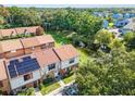 Birds eye view of townhomes overlooking a pond and green space, showcasing the community's serene setting at 3401 Sunrise Villas S Ct, Tampa, FL 33614