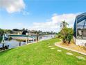 Lush backyard with a boat dock and canal access, perfect for waterfront living and outdoor activities at 3723 Toulouse Ct, Punta Gorda, FL 33950