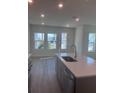 Bright kitchen featuring stainless steel appliances, a center island and gray cabinets at 160 Eagleston Ln, Lakewood Ranch, FL 34240