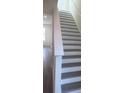 Stylish staircase featuring wood stairs and modern white railings at 160 Eagleston Ln, Lakewood Ranch, FL 34240