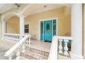Front porch with teal door and white columns at 1701 38Th Ave, St Petersburg, FL 33713