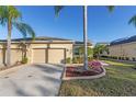 Two-car garage home with walkway and landscaping at 2429 Nottingham Greens Dr # 118, Sun City Center, FL 33573