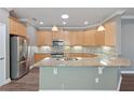 Spacious kitchen with light wood cabinets and granite countertops at 2429 Nottingham Greens Dr # 118, Sun City Center, FL 33573