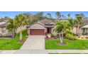 Stunning single-story home boasting an attached two-car garage, and mature tropical landscaping at 4808 111Th E Ter, Parrish, FL 34219