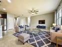 Bright and airy living room with tile floors, ceiling fan, modern furniture, and a large area rug at 4808 111Th E Ter, Parrish, FL 34219