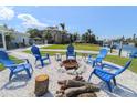 Inviting backyard fire pit area with Adirondack chairs, providing a perfect spot for relaxation and entertaining at 817 Blue Heron Blvd, Ruskin, FL 33570