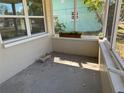 Enclosed porch with views of the outdoors offering a tranquil spot for relaxation and potted greenery at 9015 Bay Ne St, St Petersburg, FL 33702