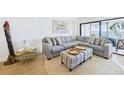 Cozy living room featuring a large sectional sofa, accent furniture, and a bright, airy atmosphere at 6365 Bahia Del Mar Blvd # 210, St Petersburg, FL 33715