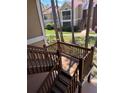 Wooden staircase leading to upper-level condos, nestled among tall pine trees at 9481 Highland Oak Dr # 715, Tampa, FL 33647